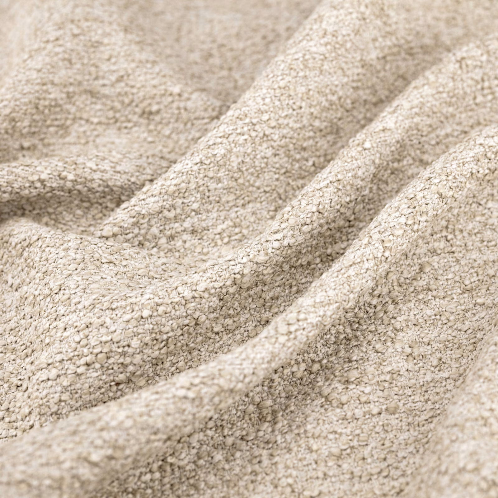 Warm ecru woven fabric with chunky flecks and deep draped folds