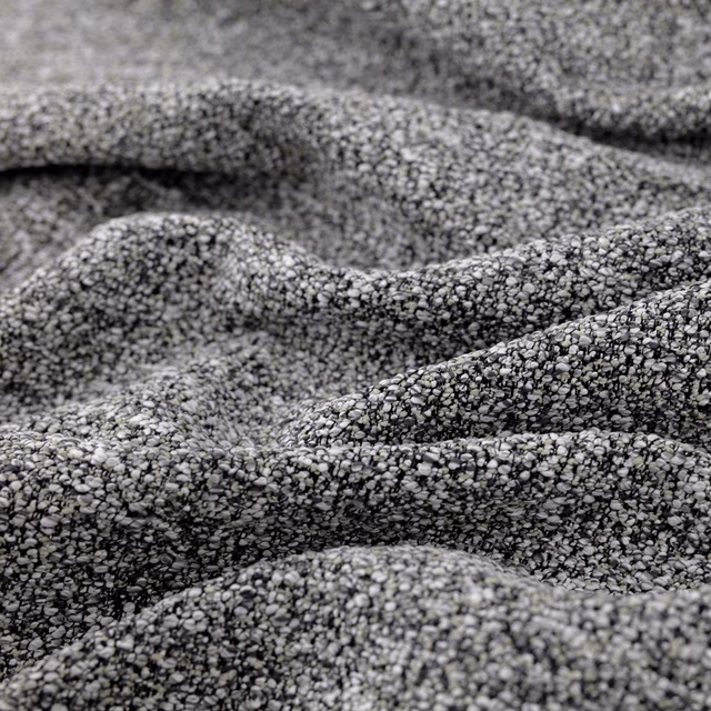 Close-up of graphite-grey nubby weave with charcoal and silver flecks