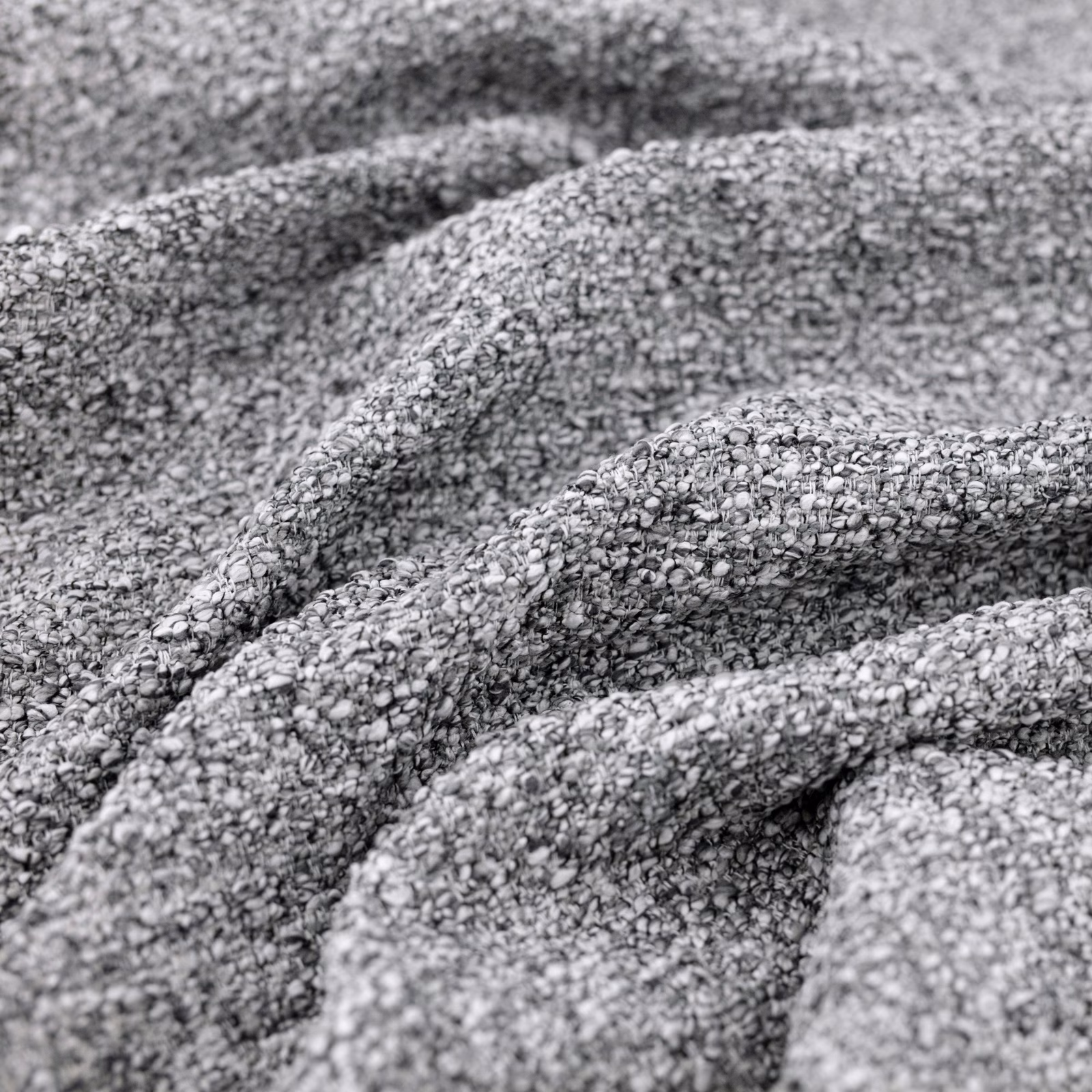 Close-up of cool grey Atlas fabric showing chunky looped weave and soft gathered folds