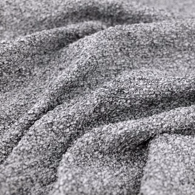 Close-up of cool grey Atlas fabric showing chunky looped weave and soft gathered folds