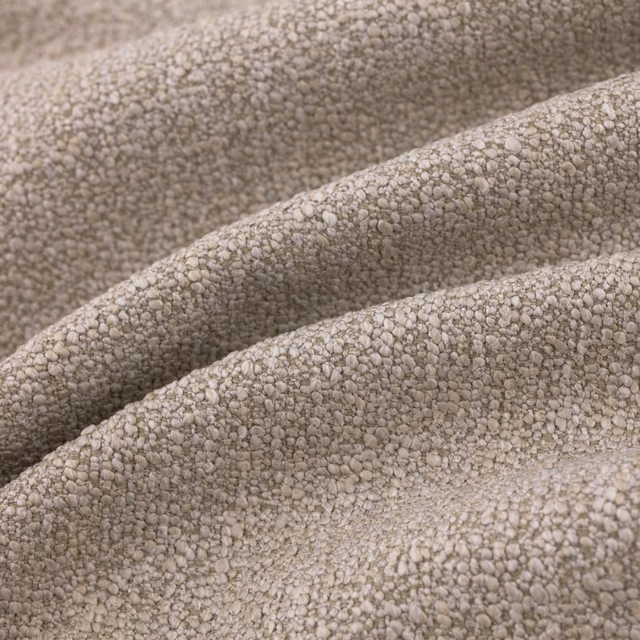 Warm taupe pebble-textured fabric draped in softly shadowed folds