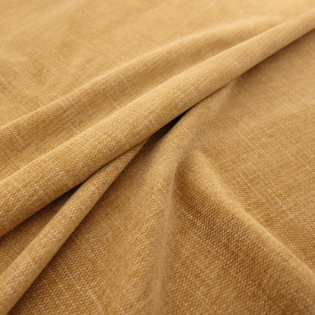 Burnished camel-gold woven fabric shown in softly raised overlapping folds
