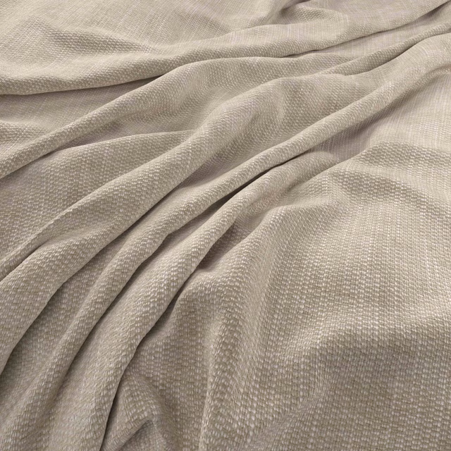 Warm ecru woven fabric with fine texture arranged in softly lit flowing folds