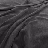 Deep charcoal-grey fabric with fine pile, softly catching light across draped folds