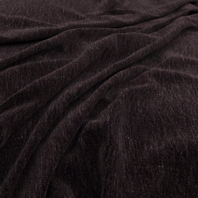 Deep raisin-brown fabric with brushed linear texture folded into soft ripples