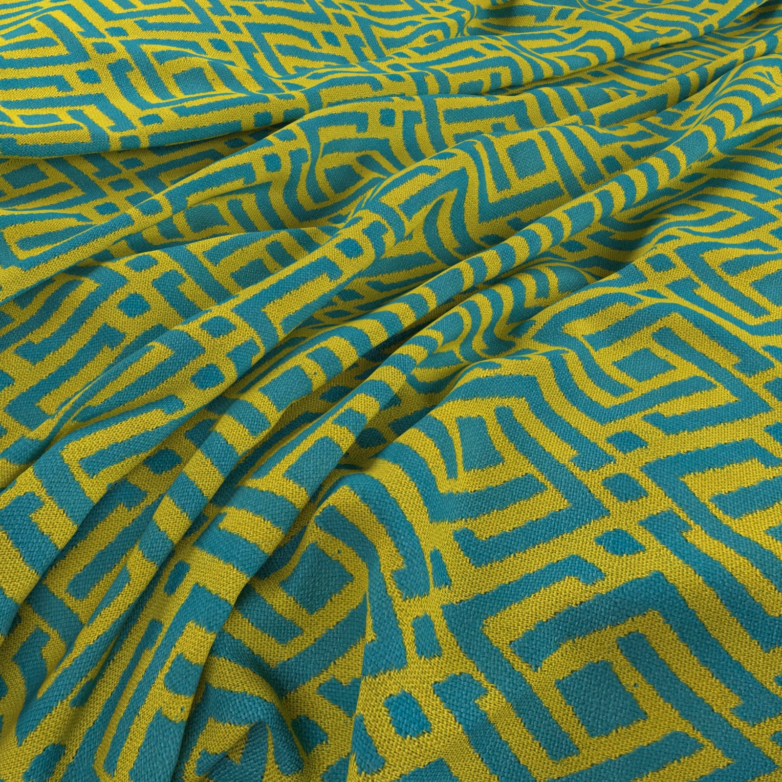 Teal and chartreuse woven fabric with an irregular maze-like geometric motif