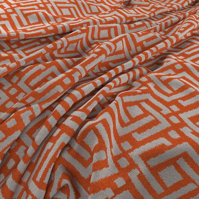 Warm tangerine and grey maze-patterned woven fabric gathered into soft folds
