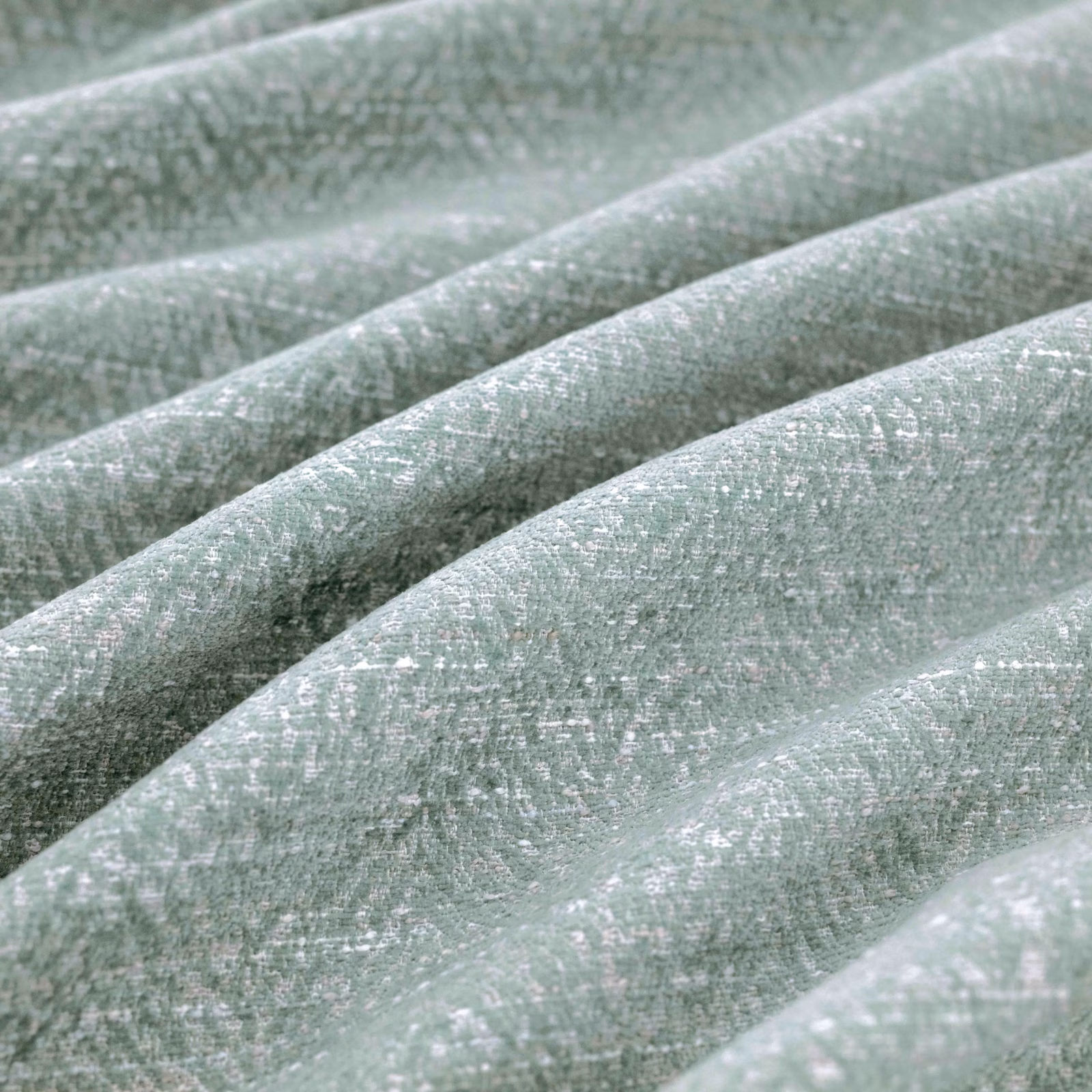 Pale sage-green Boutin Delft textile with softly flecked weave draped in broad folds