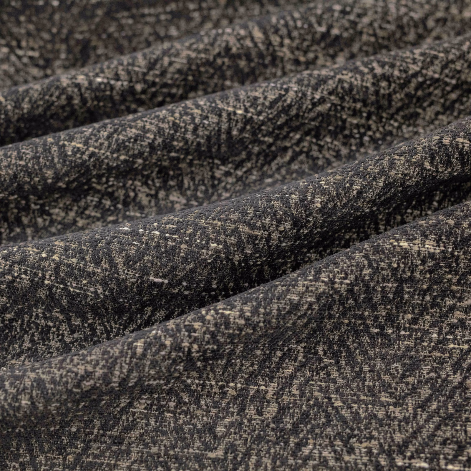 Charcoal-black Boutin textile with dense taupe flecks and a softly ridged woven surface