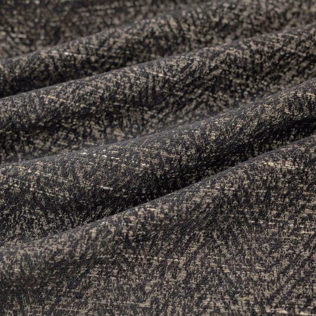 Charcoal-black Boutin textile with dense taupe flecks and a softly ridged woven surface