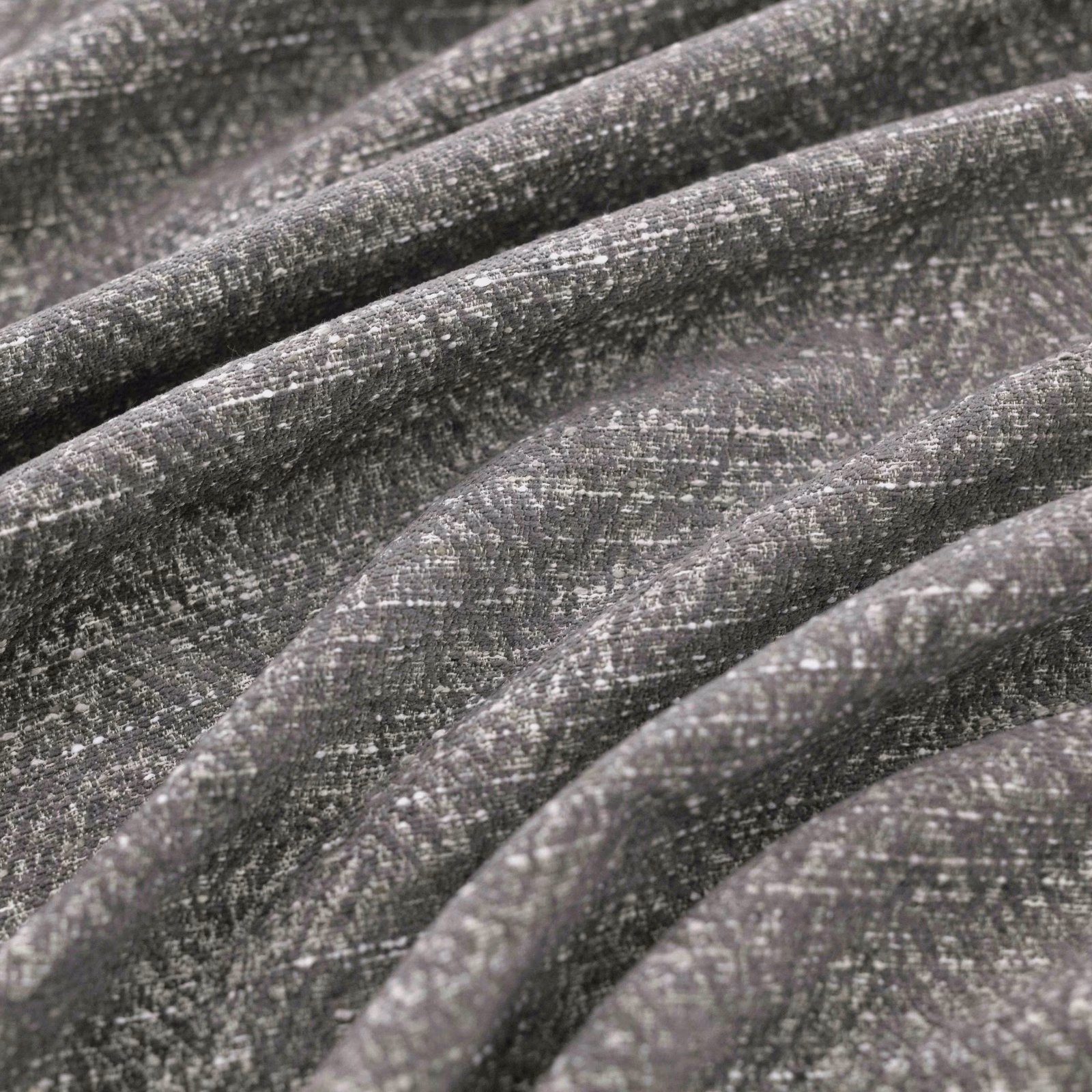 Shadow-grey woven fabric with charcoal flecks and softly ridged folds