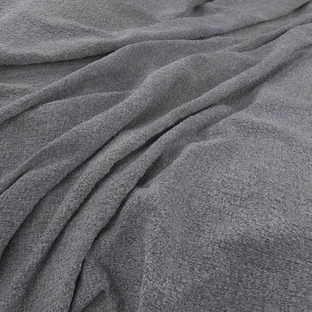 Close-up of cool charcoal-grey fabric with mottled texture and soft flowing folds