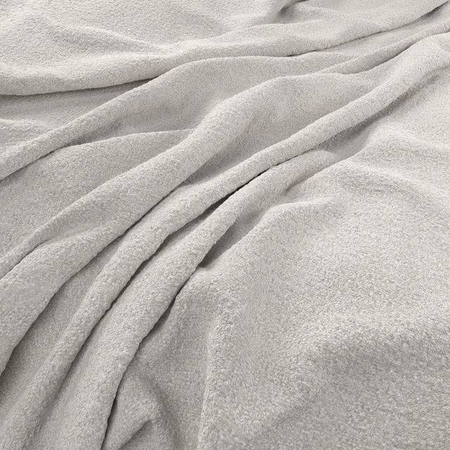 Pale cloud-grey fabric with a softly nubby surface arranged in loose folds