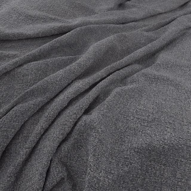 Close view of Brecon Graphite’s charcoal-grey, softly textured fabric gathered into deep folds