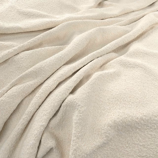 Warm ivory textile with a softly napped surface arranged in rounded, flowing folds