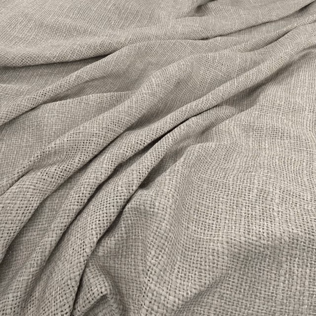 Pale greige Bruges Limewash fabric showing an open woven texture in soft folds