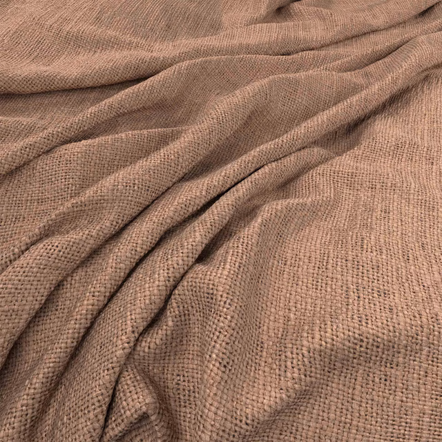 Warm nude-taupe Bruges fabric showing a softly nubby woven texture in folded drape