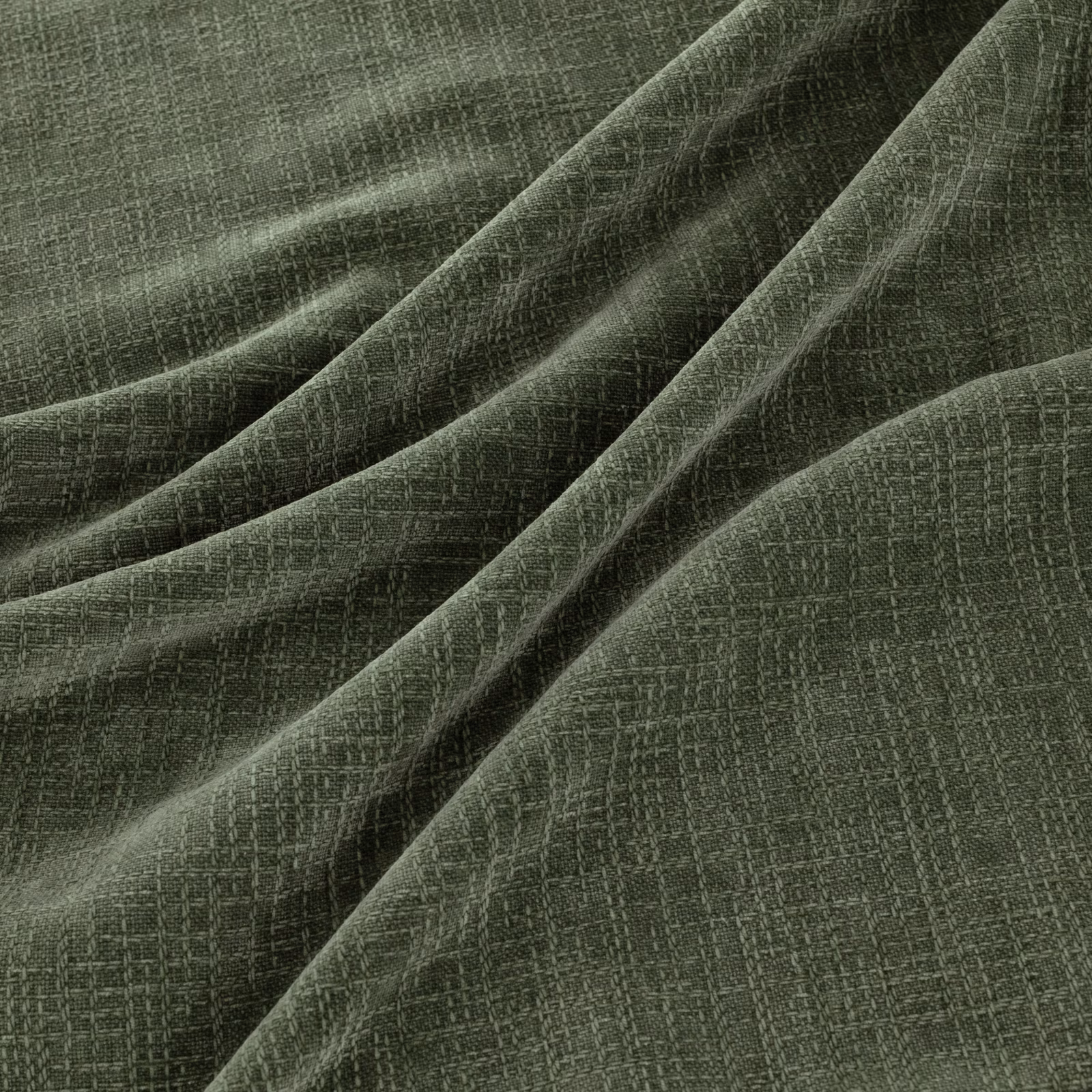 Muted sage-green crosshatched weave gathered into softly lit fabric folds