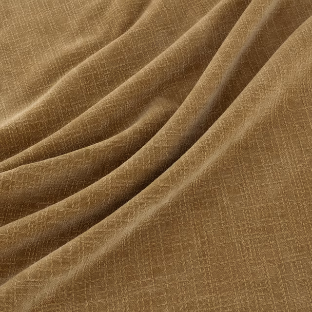 Warm camel-brown woven fabric with fine crosshatch texture in folded drape