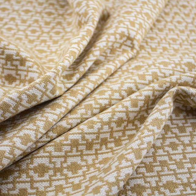 Warm jute-beige and ivory woven textile with small pixel-like geometric motifs