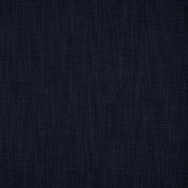Close-up of dark indigo plain-woven fabric with fine grid texture