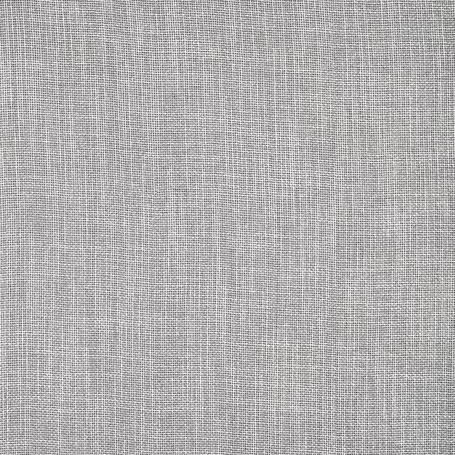 Close-up of a plain ivory woven fabric with a fine linen-like texture