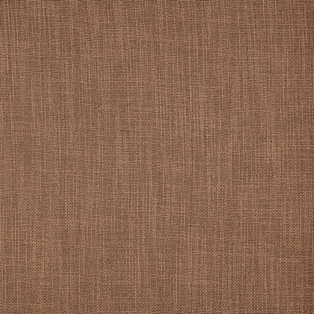 Warm peach-beige plain woven fabric with a fine open texture