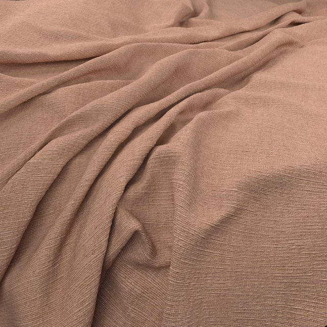 Dusty rose taupe fabric with fine horizontal weave draped in soft folds