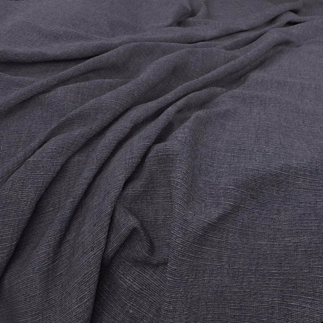 Deep blueberry-blue fabric with fine linear weave gathered into soft folds