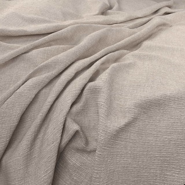 Soft greige taupe fabric with fine horizontal weave draped in gentle folds