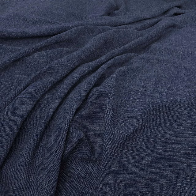 Deep navy woven fabric with fine horizontal texture gathered into soft folds