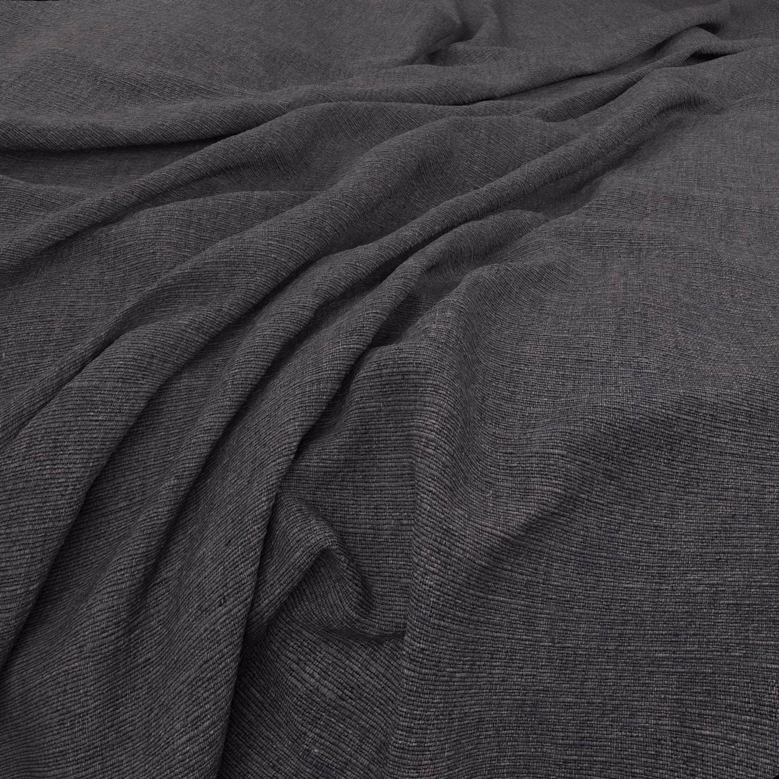 Deep charcoal fabric with fine horizontal ribbing folded into soft draped waves