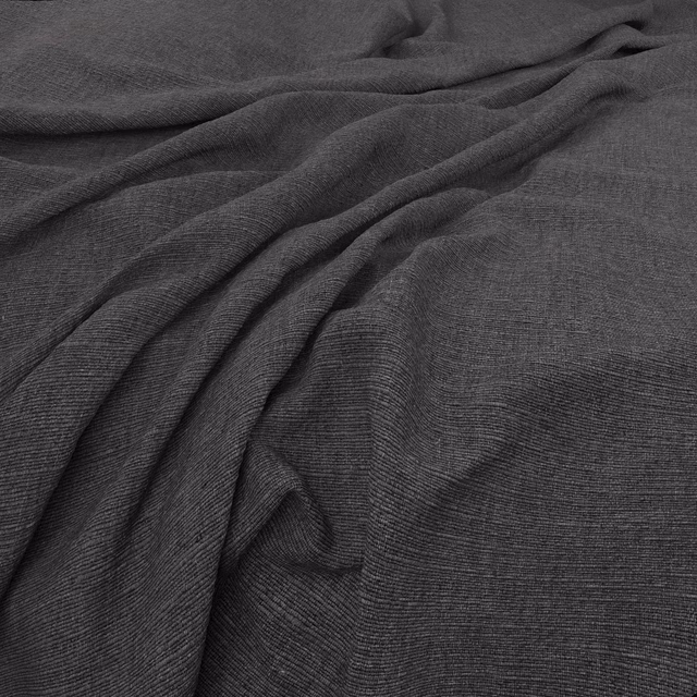Deep charcoal fabric with fine horizontal ribbing folded into soft draped waves