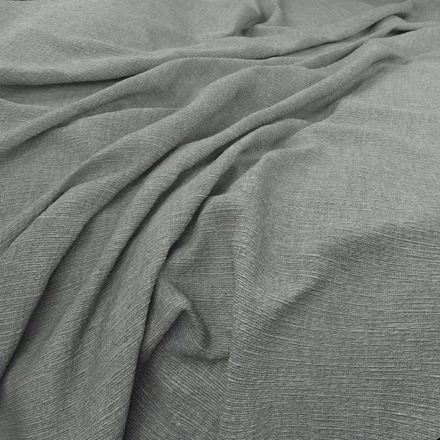 Muted seafoam green fabric with fine horizontal weave draped in soft folds