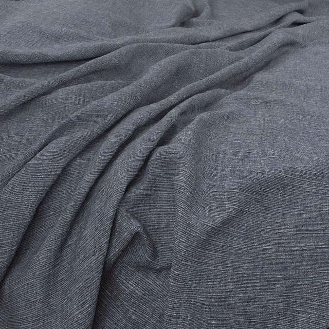 Slate blue-grey fabric with fine linear texture and softly gathered fluid folds