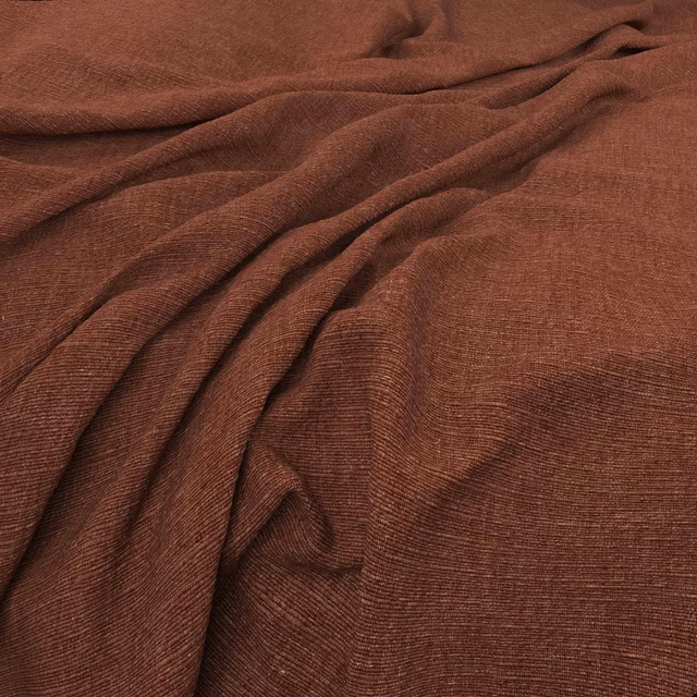 Warm russet-brown woven fabric with fine ribbing gathered into soft folds