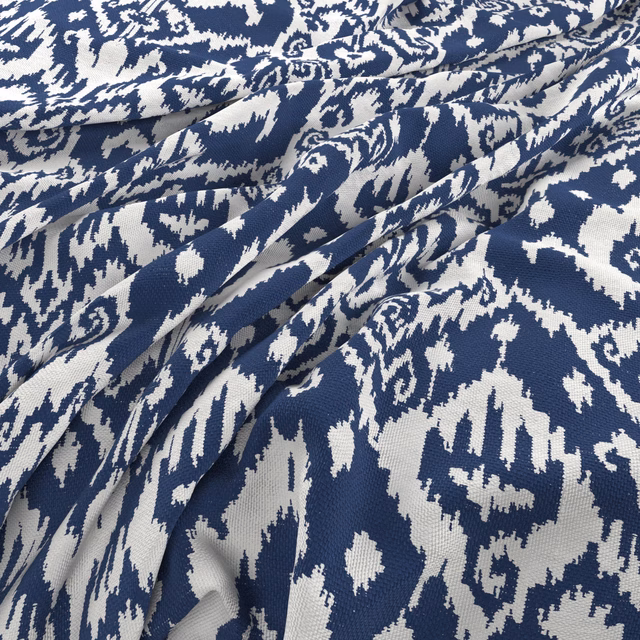 Deep azure and white folded fabric showing an irregular scrolling woven motif