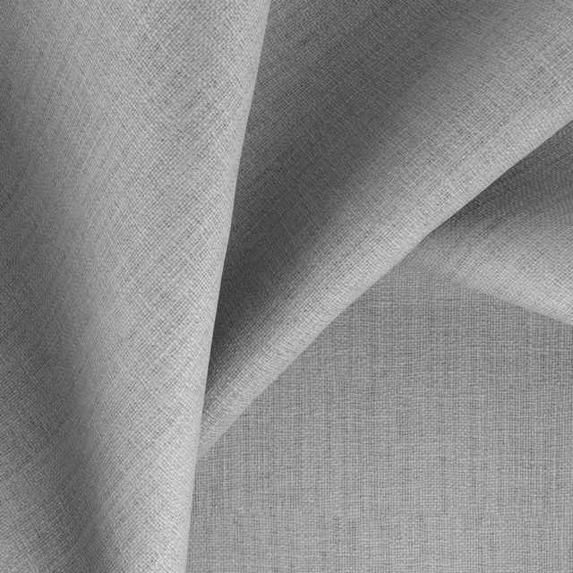 Cool ash-grey woven fabric folded to reveal fine crosshatch texture and charcoal shadows