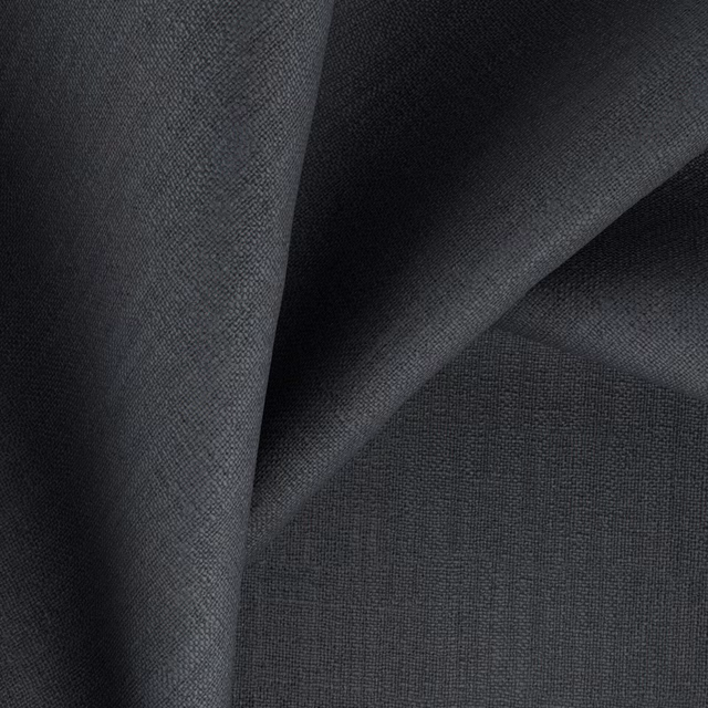 Deep charcoal woven fabric swatch with fine texture and shadowed folded surface