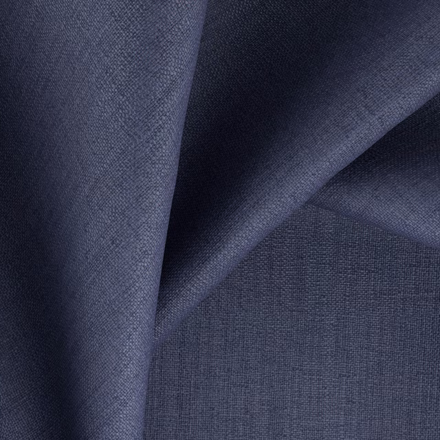 Folded swatch of deep denim blue fabric with a fine woven texture