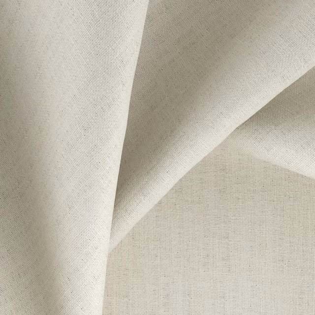 Warm ecru woven fabric swatch with fine flecks and softly folded surface