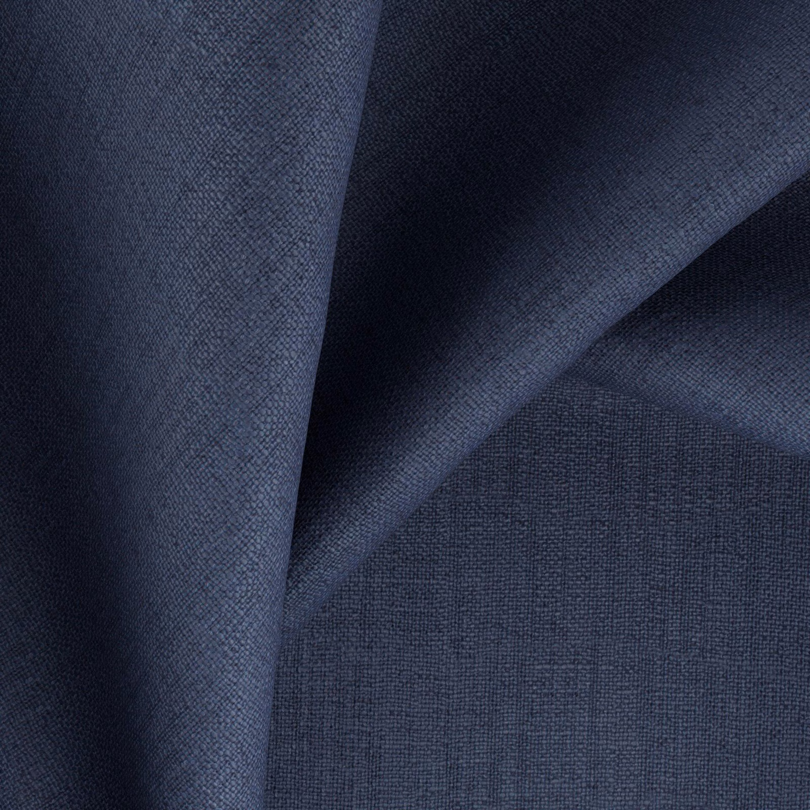 Deep indigo woven fabric showing fine crosshatch texture across folded cloth