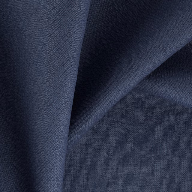 Deep indigo woven fabric showing fine crosshatch texture across folded cloth
