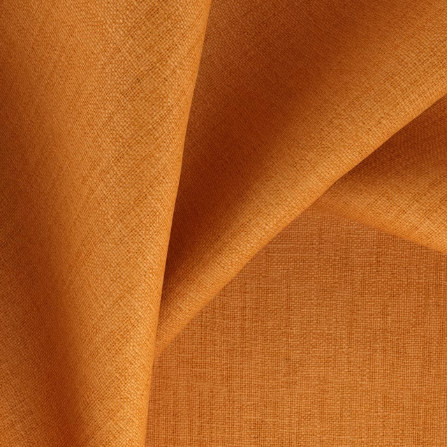 Warm marmalade-orange fabric folded to reveal a fine, even woven texture