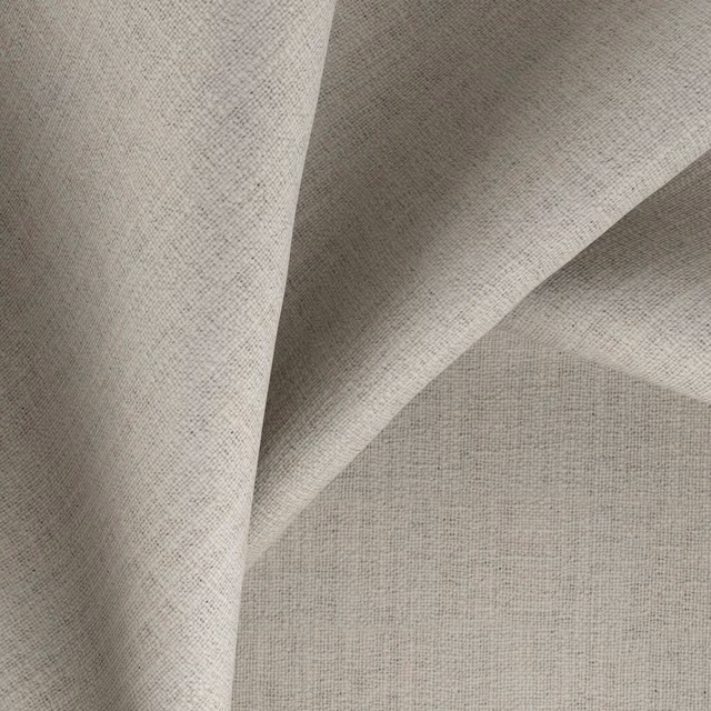 Warm putty-grey finely woven textile with softly folded, lightly textured surface