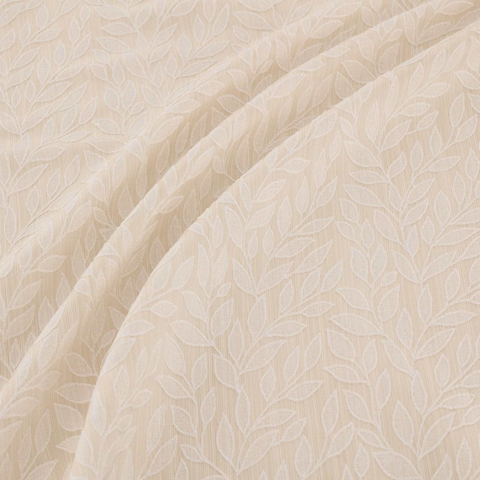 Soft ivory fabric with tonal outlined leaves and gentle draped folds