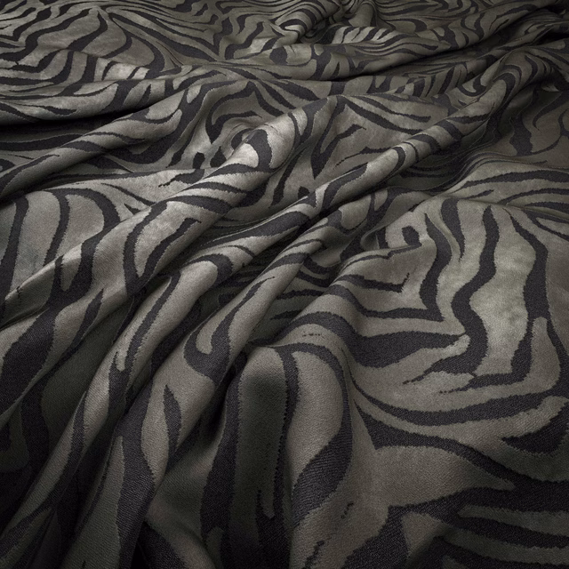 Dark olive-grey fabric with charcoal zebra stripes and softly gathered folds