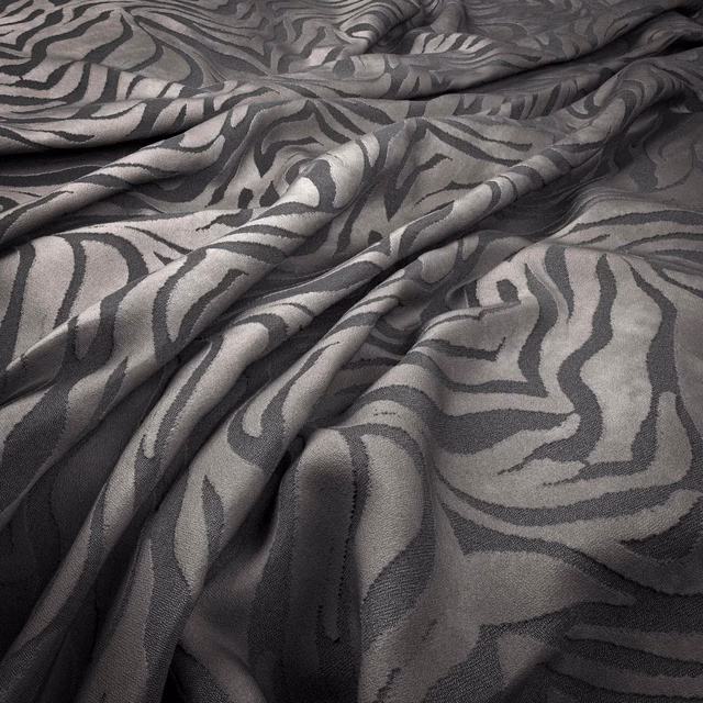 Warm mink-grey woven fabric with charcoal zebra stripes and softly textured surface