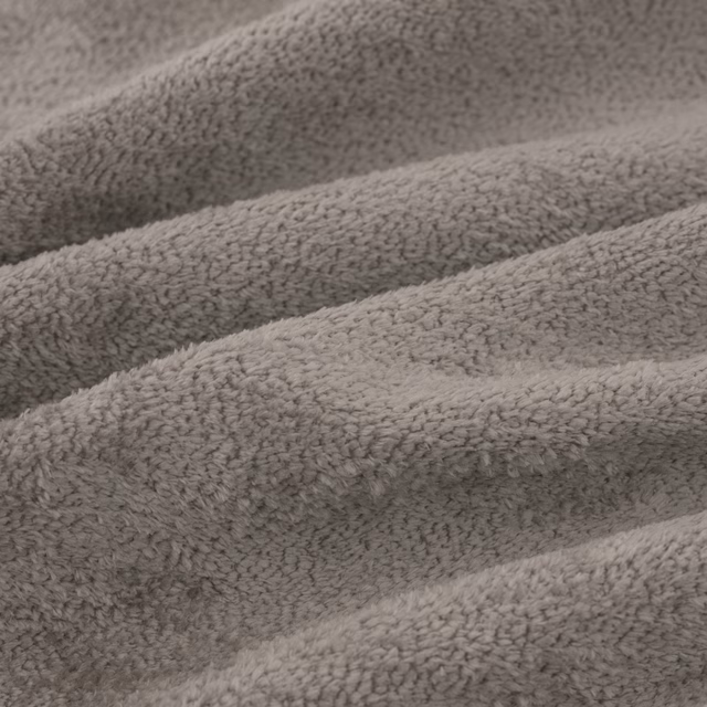 Close-up of mushroom-grey Cecconi fabric with dense plush, nubby woven texture