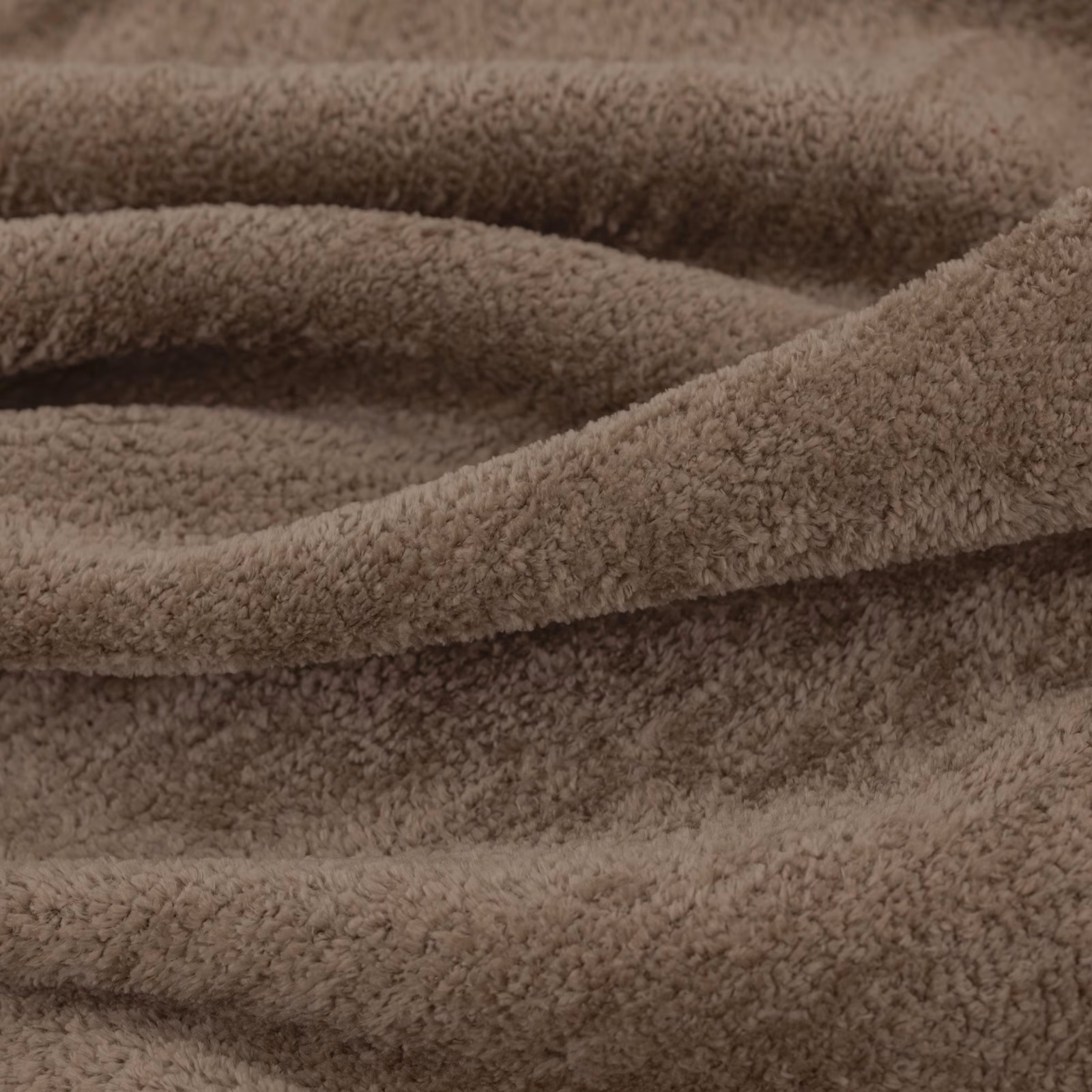 Warm chestnut-brown plush pile folded into soft, shadowed ridges